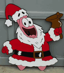 patrick star from spongebob squarepants is dressed as santa claus and holding a bell .