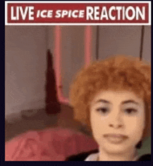 a woman with red hair is taking a selfie in front of a sign that says live ice spice reaction .