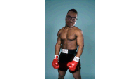 a man wearing everlast shorts and boxing gloves stands in front of a blue background