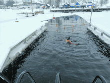 a person is swimming in a body of water with a sign that says ' a ' on it