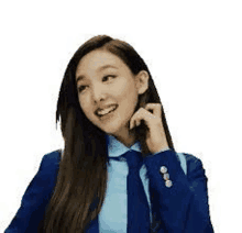 a woman in a suit and tie is smiling and talking on a cell phone .