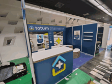 an empty totum pharmacie booth with a white counter top