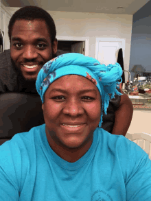 a man and a woman are posing for a picture and the woman is wearing a blue shirt that says maryland