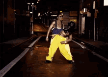 a man and woman are dancing on a wet street in front of a sign that says ' chinese restaurant '