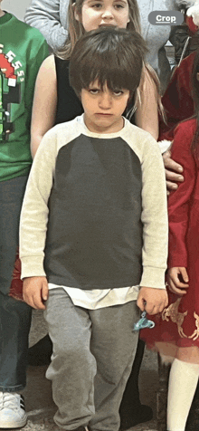 a group of children are posing for a picture and one of them is wearing a shirt that says crop on it