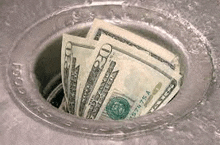 a bunch of money is sticking out of a drain .