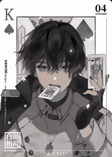 a boy is holding a playing card in his hand .