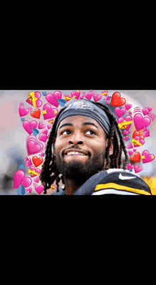 a man wearing a headband with the word eagles on it is surrounded by pink hearts