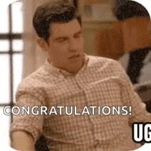 a man in a plaid shirt is sitting down and saying `` congratulations ! ''