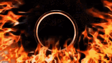 a black circle is surrounded by flames on a dark background