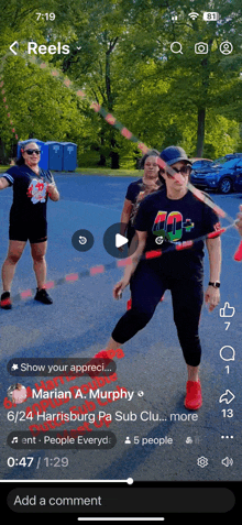 a phone screen shows a video of a woman doing hula hoops