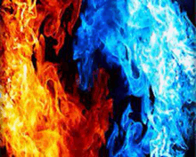 a close up of a red and blue fire on a dark background .