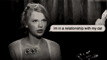 a black and white photo of taylor swift talking to ellen .