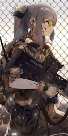 a girl with a tattoo on her arm is holding a gun in front of a chain link fence