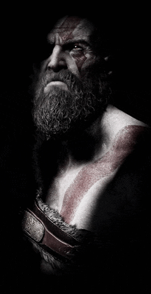 a man with a beard and red paint on his face and chest