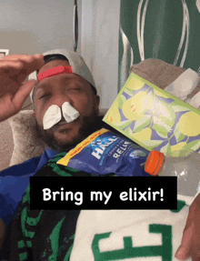 a man laying on a couch with tissues and a bag of hall 's cold & flu relief on his nose