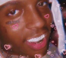 a close up of a person 's face with hearts on it and hearts coming out of his mouth .