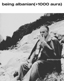 a black and white photo of a man smoking a cigarette and the caption being albanian