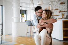 a man is carrying a woman in a hammock