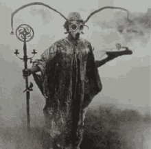 a black and white photo of a man wearing a gas mask and holding a sword