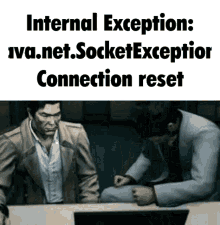 two men are sitting at a table looking at a computer screen with the words " internal exception : iva.net.socket exception connection reset "