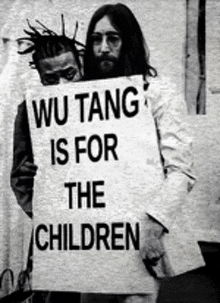 a man holding a sign that says wu tang is for the children .