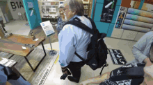 a man in a blue shirt is kneeling down in front of a sign that says " farba specialty "