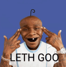 a man with a tooth in his mouth is making a funny face with the words leth goo written below him