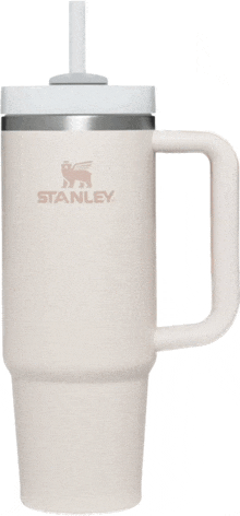 a white stanley mug with a handle and straw