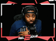 a man wearing headphones giving a thumbs up in front of mel solid