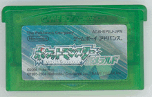 a green game boy advance cartridge that says pokemon