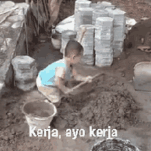 a young boy is kneeling in the dirt with a shovel and buckets and the words kerja ayo kerja written on the bottom