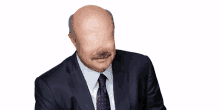 a bald man in a suit and tie with a mustache