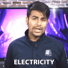 a man wearing a shirt that says electricity