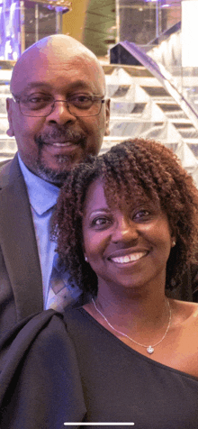 a man and woman posing for a picture and smiling