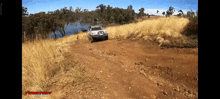 a car is driving down a dirt road with a sign that says ' texas off road ' on the bottom