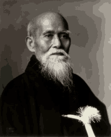 a man with a long beard is holding a white flower