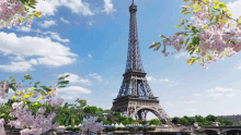 the eiffel tower is surrounded by flowers and trees