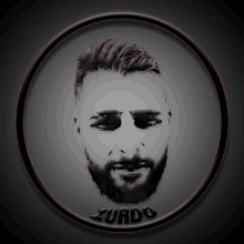 a black and white photo of a man 's face with zurdo written below it