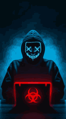 a man wearing a neon mask is using a laptop