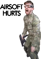 a man in a camouflage uniform is holding a gun with the words " airsoft hurts " above him