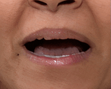 a close up of a woman 's mouth with her mouth open