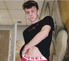 a man is wearing red diesel underwear