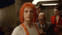 a woman with orange hair is wearing a white sweater