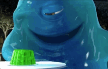 a blue monster with a green jelly on a white plate