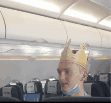 a man wearing a mask and a crown on a plane