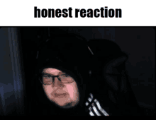 a picture of a man with glasses and a hood with the words honest reaction below him