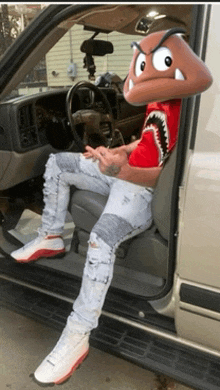 a man in a shark shirt is sitting in a car