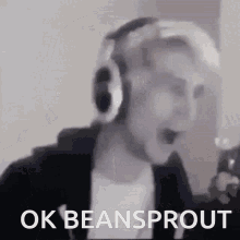 a man wearing headphones says ok beansprout in front of a microphone