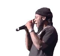 a man singing into a microphone wearing a black hat